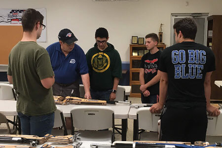 Rifle Team study air rifles.