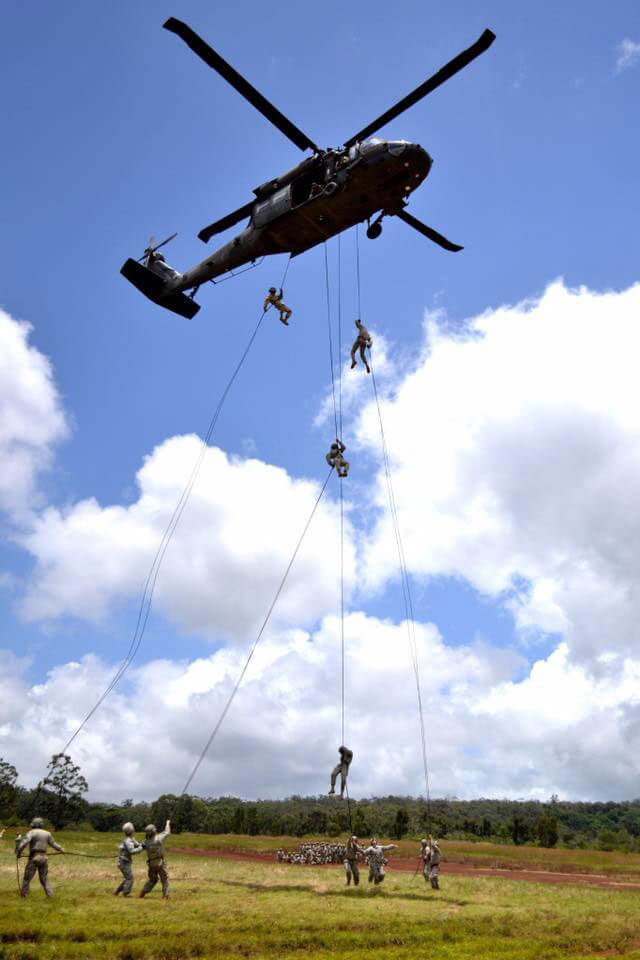 Cadets rappel down from a helicopter.