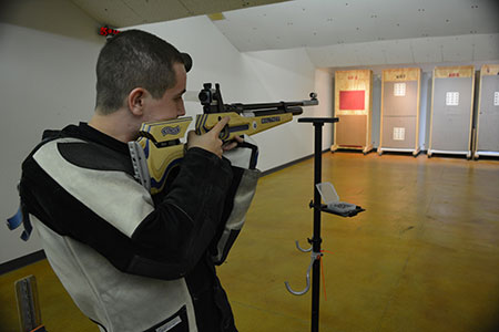 Student takes aim with an air rifle.