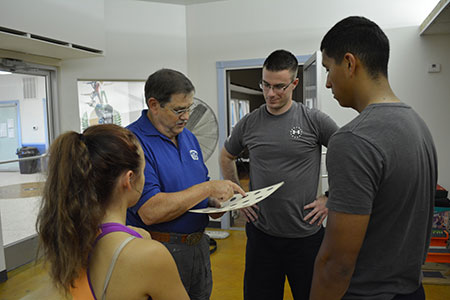 Coach Miller teaches his students.